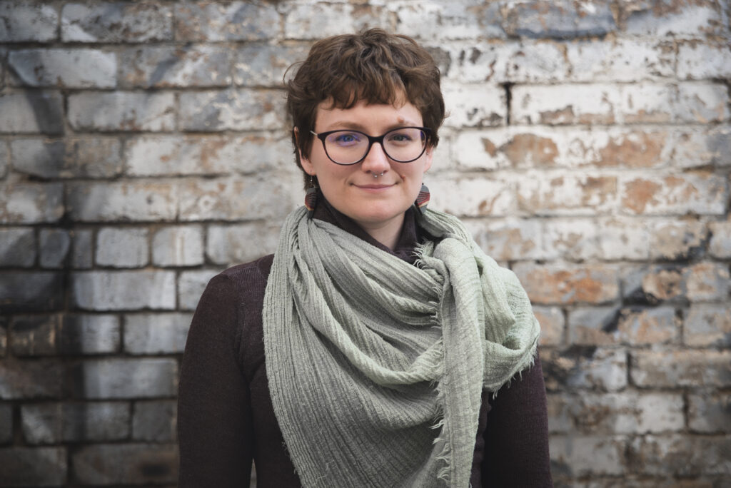 Chloe Lyth pictured standing in front of a brick wall, image by Kat Gollock